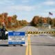 us canada border road closure — gravel road along Alberta-Montana boundary near Coutts with prairie landscape and border markers